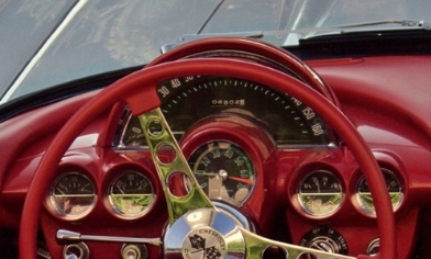 Vintage Chevrolet Corvette red dashboard with red steering wheel with chrome trims