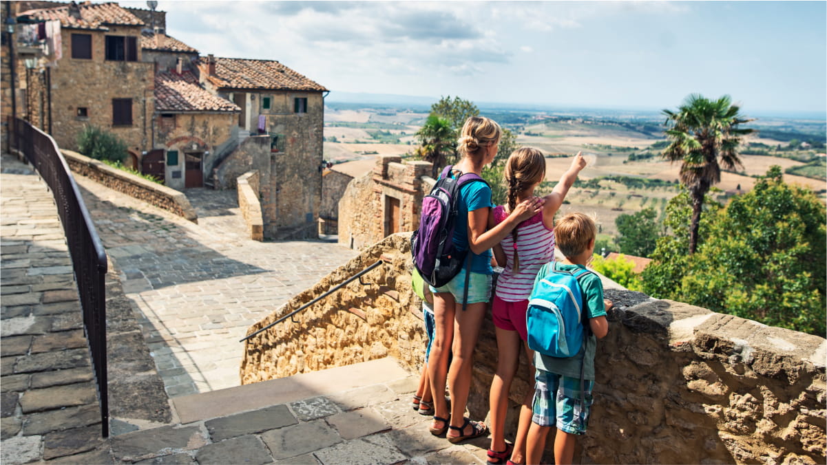 Mother with her young daughter and son standing on and old town path looking out to the distance