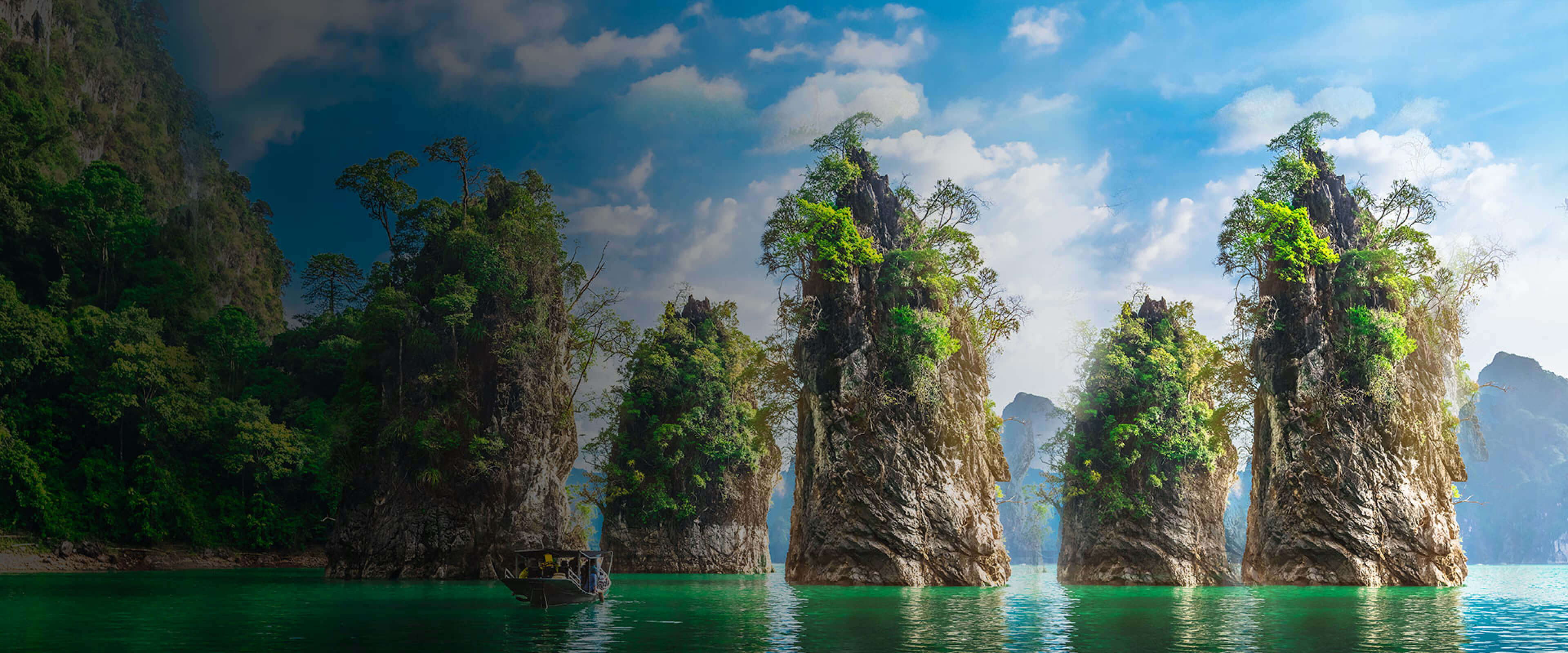 scenic view in Vietnam with trees, mountains and a boat in the sea