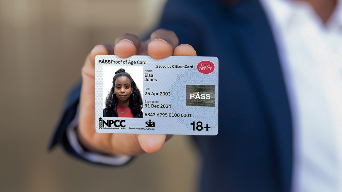 Man holding a Post Office Pass card