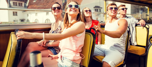 A group of friends on the top deck of a tourist bus