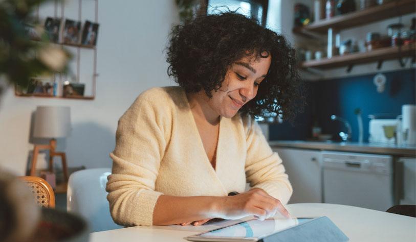 A woman scrolls through an iPad